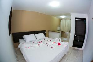 En eller flere senge i et værelse på Pousada Maravelas By OM