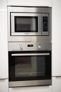 a microwave oven sitting inside of a kitchen at Spacious Fully Equipped 3BD 2Bath Apt in the heart of city with Balconies AC and fast WIFI #1 in Heraklio Town