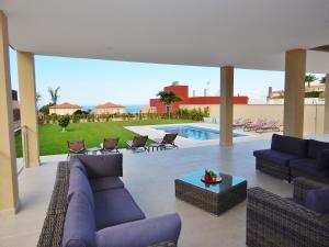 a living room with purple furniture and a pool at 5 bedrooms Villa Costa Adeje in Adeje