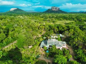 an aerial view of a house with mountains in the background at Sinhagiri Villa in Sigiriya