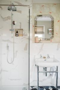 a bathroom with a sink and a shower at The Naight House in Gloucester