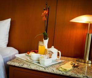 a tray of breakfast food on a table in a hotel room at Holiday Inn Puebla Finsa, an IHG Hotel in Puebla