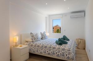 a bedroom with a bed and a window at L'Ancora Beach in Jávea