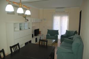 a living room with a couch and a table and chairs at Hortes 7 in Girona