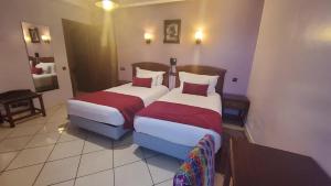 Ένα ή περισσότερα κρεβάτια σε δωμάτιο στο Hôtel Amouday