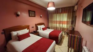 Ένα ή περισσότερα κρεβάτια σε δωμάτιο στο Hôtel Amouday