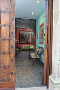 a wooden door in a room with chairs at Palacio Sirvente Mieres - PARKING GRATUITO in Andújar