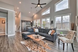 a living room with a couch and a table at Scenic Hillside Cabin in Sylva with Hot Tub and Views! in Sylva