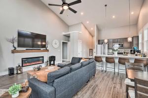 a living room with a couch and a table at Scenic Hillside Cabin in Sylva with Hot Tub and Views! in Sylva
