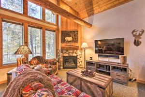 a living room with a couch and a fireplace at Klamath Falls Cabin Retreat with Deck and Grill! in Klamath Falls