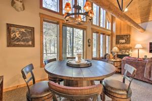 a dining room with a wooden table and chairs at Klamath Falls Cabin Retreat with Deck and Grill! in Klamath Falls
