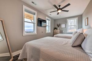 a bedroom with two beds and a ceiling fan at Scenic Hillside Cabin in Sylva with Hot Tub and Views! in Sylva