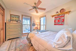a bedroom with a bed and a ceiling fan at Serene Cabin with Riverfront Views and Access! in Fayetteville