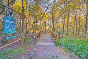 a wooden bridge in the middle of a forest at Serene Cabin with Riverfront Views and Access! in Fayetteville