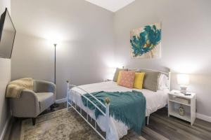 a bedroom with a bed and a chair at The Sanctuary Company Johnson City in Johnson City