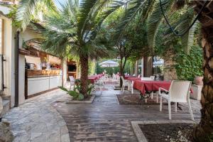 A garden outside Corte Cristina & Suites