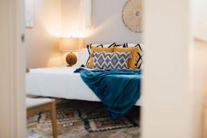 a bedroom with a bed with blue sheets and pillows at The Sanctuary Company Johnson City in Johnson City