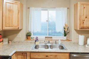 a kitchen counter with a sink and a window at The Sanctuary Company Johnson City in Johnson City