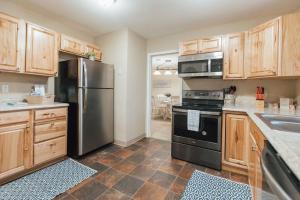a kitchen with stainless steel appliances and wooden cabinets at The Sanctuary Company Johnson City in Johnson City +37 photos