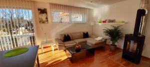 a living room with a couch and a table at Seeidylle Winkler in Bodensdorf