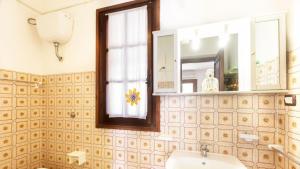 a bathroom with a sink and a mirror at Case Vacanza Aiosardegna Porto Columbu in Porto Columbu - Perdʼe Sali +72 photos