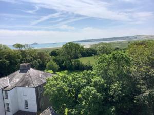 an aerial view of a house with trees and water at Kilmahon House, P25A973 in Shanagarry