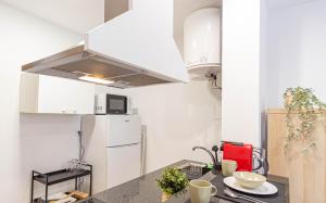 a kitchen with a refrigerator and a counter top at Belem Studio - Near Main Touristic Area in Lisbon
