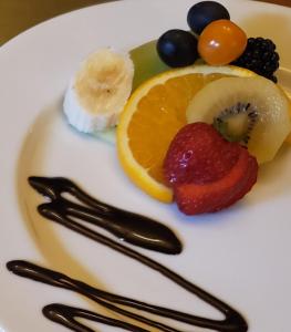 a plate of fruit on a white plate at Avonview Manor in Stratford