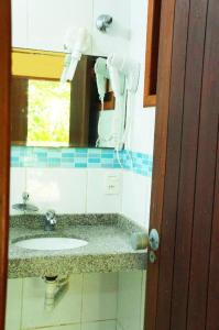 a bathroom with a sink and a mirror at Pousada Baobá in Olinda