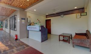 a lobby with a reception desk in a building at Treebo Trend Jeevan Village in Panchgani