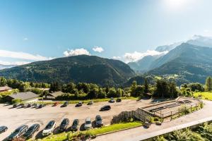 a parking lot with mountains in the background at Furnished studio at the foot of the slopes with a balcony & mountains view in Saint-Gervais-les-Bains