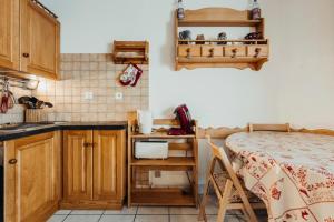 a kitchen with a bed and a table in a room at Apartment with balconies ski-in ski-out classified 2 stars in Saint-Gervais-les-Bains