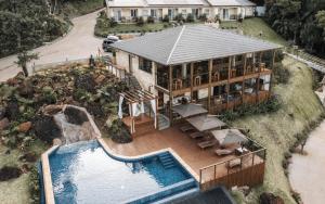 an aerial view of a house with a swimming pool at Discovery Canyon in Praia Grande
