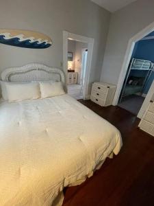 a bedroom with a large white bed in a room at Surf Shack on 24th in Galveston
