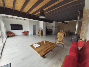 sala de estar con sofá rojo y mesa en domaine de codeval, en Fronton