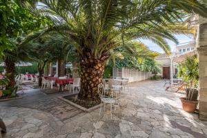 A garden outside Corte Cristina & Suites