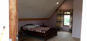 a small bedroom with a bed in a attic at Bagamoyo Home Stay in Bagamoyo