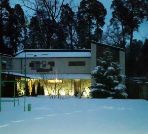 a building in the snow at night at Park Puscha Sauna Deluxe Apartment & Terrace in Kyiv