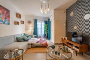een woonkamer met een bank en een tv bij Apartment with terrace and garage Classified 4 stars in Annecy