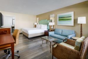 a hotel room with a bed and a living room at Coco Key Hotel & Water Park Resort in Orlando