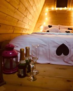 Zimmer mit einem Bett mit Flaschen und Gläsern auf dem Tisch in der Unterkunft Holiday home Green Kiss in Vinkovci