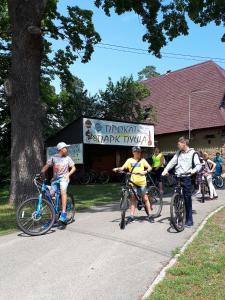 a group of people riding bikes down a sidewalk at Park Puscha Sauna Deluxe Apartment & Terrace in Kyiv
