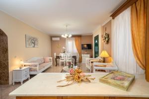 a living room with a couch and a table at Artemis superb 2 bedroom apartment 700 m away from the beach in Minia