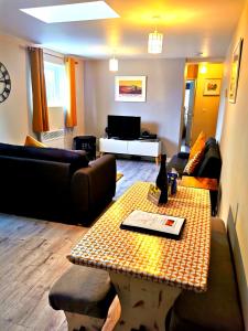 a living room with a couch and a table at Sunflower Apartment, Family accommodation Near Tenby in Pembrokeshire in Tenby