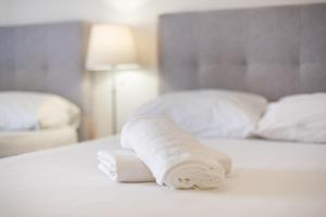 A bed or beds in a room at Athens Dreams & Suites Apartments