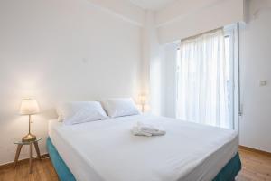 A bed or beds in a room at Athens Dreams & Suites Apartments