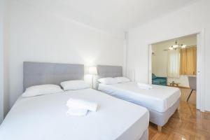 A bed or beds in a room at Athens Dreams & Suites Apartments