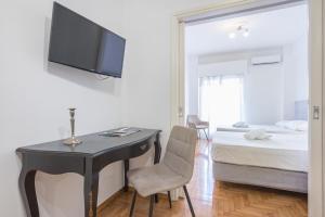 A television and/or entertainment centre at Athens Dreams & Suites Apartments