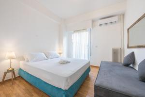 A bed or beds in a room at Athens Dreams & Suites Apartments