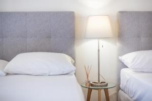 A bed or beds in a room at Athens Dreams & Suites Apartments